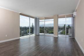 Apartments in Palo Alto, CA - Tan Plaza - Living Area with Wood-Style Flooring, Window Walls, and Sliding Glass Door with Access to Balcony.