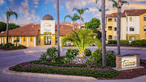 A beautifully landscaped entrance to a residential complex with a sign that reads "Tulumara".