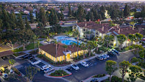 A residential area with a swimming pool and a parking lot.