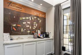 A site map is displayed on a wall above a reception desk.