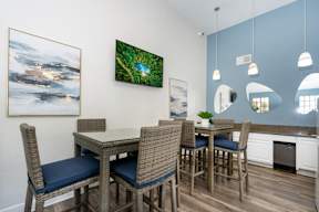 A dining room with a table and chairs.