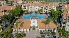 An aerial view of a resort with a swimming pool and a gazebo.
