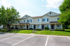 a large house with a parking lot in front of it