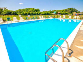 a large swimming pool with chairs around it