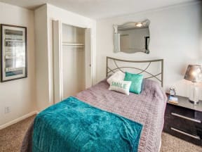 a bedroom with a bed and a mirror