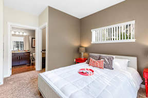 Bedroom with white bedding and modern decor at Mullan Reserve Apartments, Missoula, MT 59808