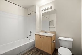 a bathroom with a toilet sink and bathtub at Mill Pond Apartments, Washington, 98092