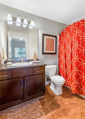 Bathroom with double vanity and red shower curtain at Mullan Reserve Apartments, Missoula, Montana