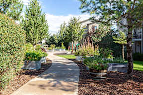 Community garden pathway with raised planter beds at Mullan Reserve Apartments, Missoula, MT 59808