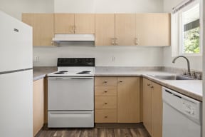 a kitchen with white appliances and wooden cabinets at Mill Pond Apartments, Washington, 98092