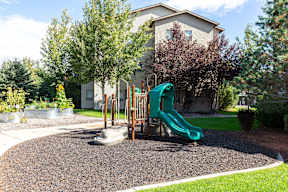 Playground with slide and climbing equipment at Mullan Reserve Apartments, Montana, 59808