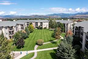 Courtyard with manicured lawn and walking paths at Mullan Reserve Apartments, Missoula, MT