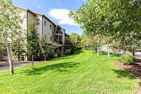 Apartment buildings with landscaped lawn and trees at Mullan Reserve Apartments, Missoula, 59808