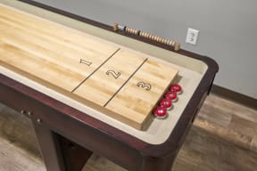 a game of shuffleboard on a table at Mill Pond Apartments, Washington, 98092