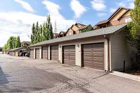 Detached garages with brown doors and siding at Mullan Reserve Apartments, Missoula, Montana