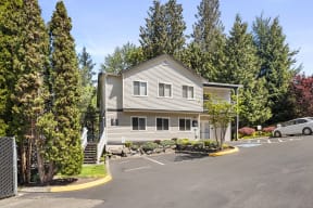 a house with a parking lot in front of it at Mill Pond Apartments, Auburn Washington