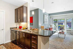 Open concept kitchen with granite countertop and bar seating at Mullan Reserve Apartments, Missoula, 59808