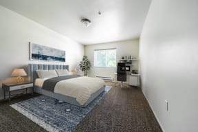 a bedroom with a bed and a desk at Mill Pond Apartments, Washington