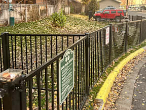 Dog park with rules sign and metal fencing at Mullan Reserve Apartments, Missoula, Montana