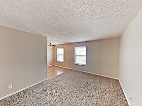 the living room and dining room of an empty house