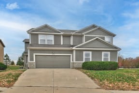 a house with a driveway and a garage door