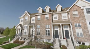 a row of brick apartment buildings on a sunny day