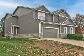 a house with a driveway and a garage door