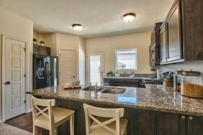 a kitchen with a granite counter top and a sink