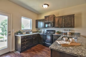 a kitchen with black appliances and granite counter tops