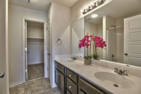 a bathroom with two sinks and a large mirror