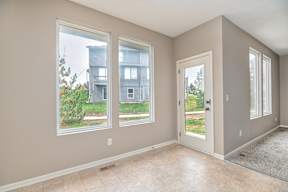 A room with a view of a building through the windows.