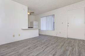 A room with a white ceiling, a white door, and a white cabinet.