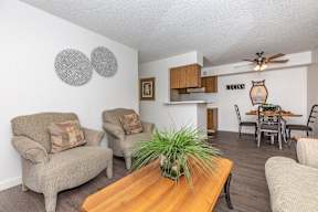 A living room with a wooden table and two couches.