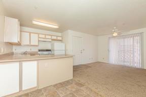 A kitchen with white cabinets and a tiled floor.