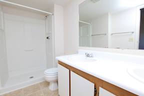 A white bathroom with a toilet and a sink.