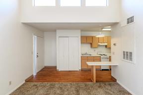 A kitchen with white cabinets and a wooden island.