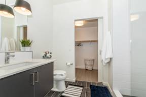A bathroom with a white toilet and a white sink.