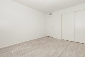 A room with a wooden floor and white walls.