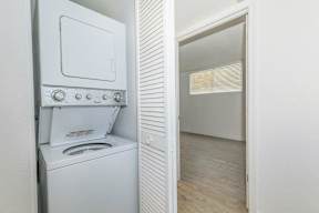 A white oven with a stove top and a microwave is in a kitchen.