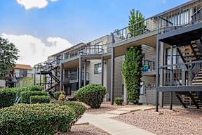 Apartment complex with a walkway between the buildings.