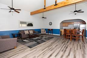 A living room with a couch, chairs, and a dining table.