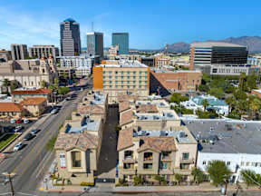 A city street with apartment buildings and cars.
