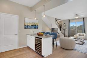 A modern kitchen with a white cabinet and a painting on the wall.