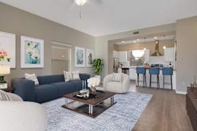 A living room with a blue couch and a coffee table.