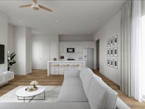 A modern living room with a white sofa, a coffee table, and a ceiling fan.