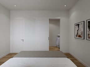 A white bedroom with a bed in the center and two pictures on the wall.
