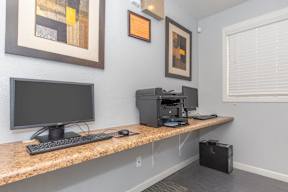 A workspace with a monitor, keyboard, and mouse on a countertop.