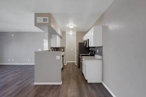 A kitchen with white cabinets and a microwave above the stove.