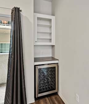 A kitchen with a stainless steel oven and a white cabinet.