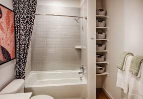 A white bathroom with a tub, toilet, and sink.